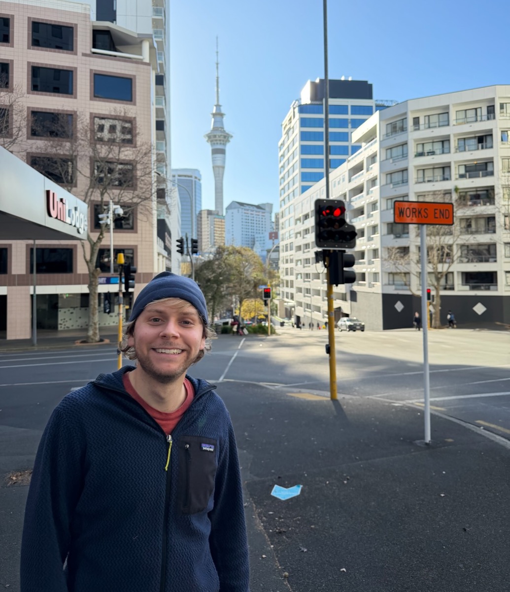 Sam, standing at a city crossing
